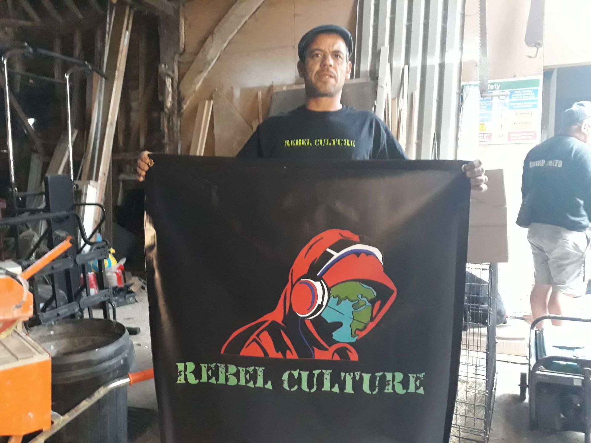 Crew member holding the Rebel Culture banner at the Launch Party 2019
