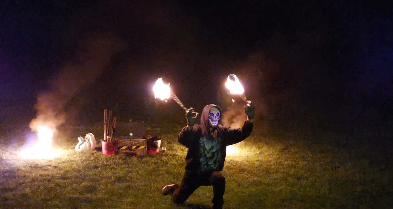 Fire performer in skull mask at the Rebel Unit party
